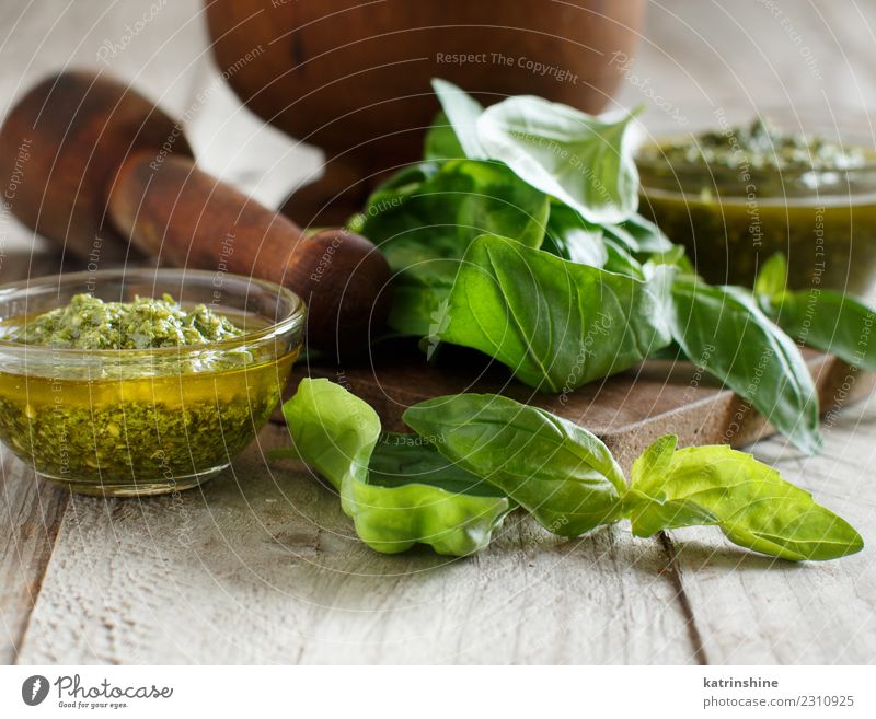 Pesto sauce and fresh basil on a wooden table Vegetarian diet Bowl Gastronomy Leaf Fresh Natural Green Tradition Aromatic Basil pesto condiment cooking dressing