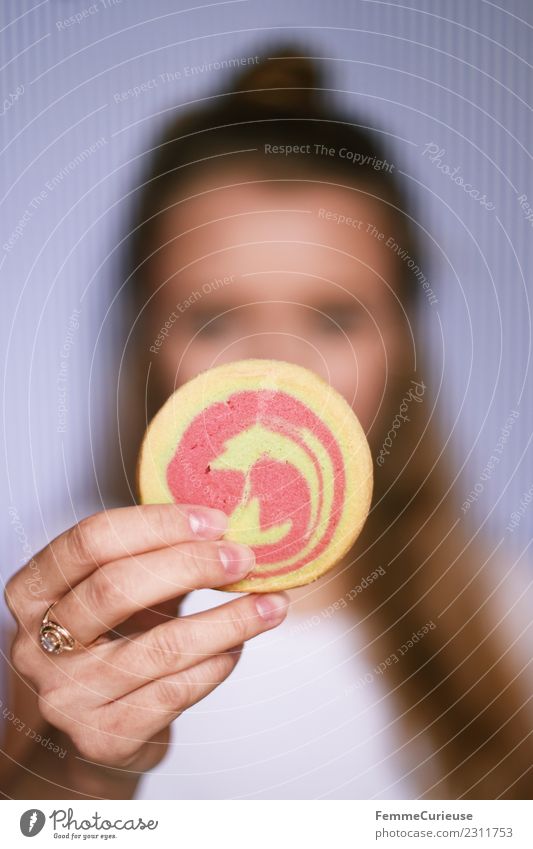 Young woman showing cookie into the camera Food Youth (Young adults) Woman Adults 1 Human being 18 - 30 years To enjoy Butter cookie Baked goods Candy Dough