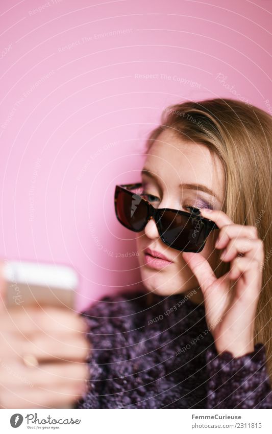 Girl with sunglasses taking a self portrait with smartphone Lifestyle Elegant Style Technology Entertainment electronics Feminine Young woman