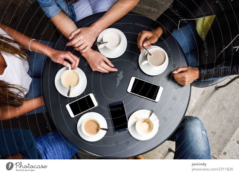 Coffee cups and smartphones on table in a urban cafe. Breakfast Beverage Lifestyle Shopping Table Meeting To talk Telephone PDA Human being Young woman