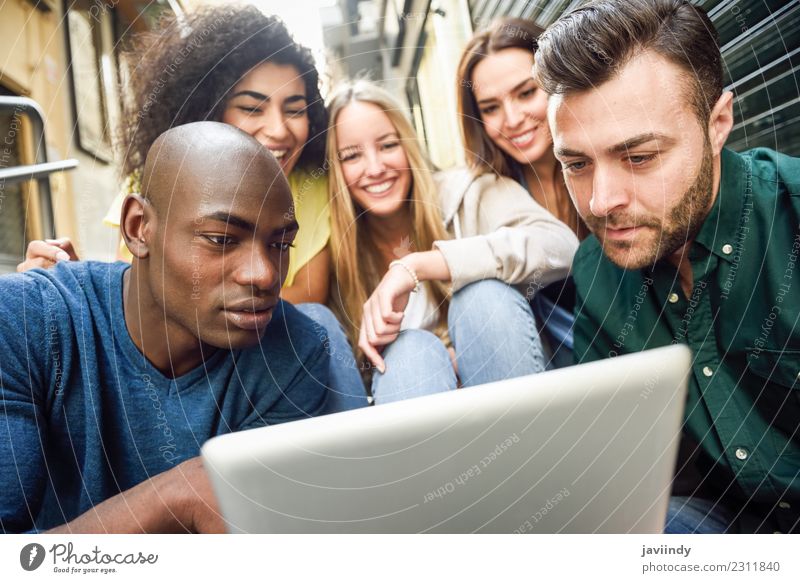 Multi-ethnic group of young people looking at a tablet computer outdoors Lifestyle Joy Happy Beautiful Young woman Youth (Young adults) Young man Woman Adults