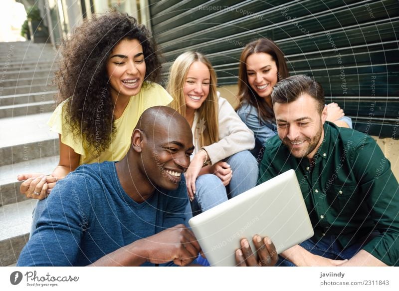 Multi-ethnic young people looking at a tablet computer Lifestyle Joy Happy Beautiful Human being Young woman Youth (Young adults) Young man Woman Adults Man