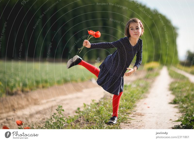 Funny little girl in nature with poppies in her hand. Lifestyle Joy Happy Beautiful Playing Summer Child Human being Girl Woman Adults Infancy 1 3 - 8 years