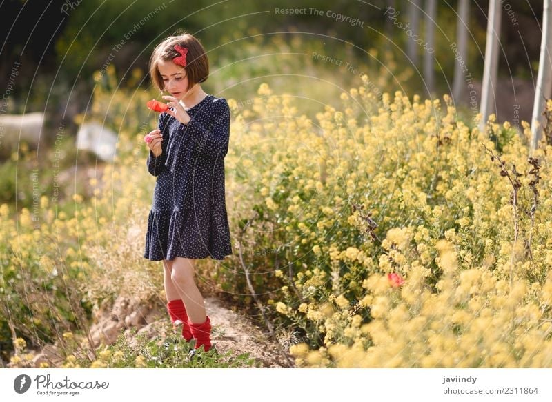 Little girl in nature wearing dress with a poppy in her hand. Lifestyle Joy Happy Beautiful Playing Summer Child Human being Girl Woman Adults Infancy 1