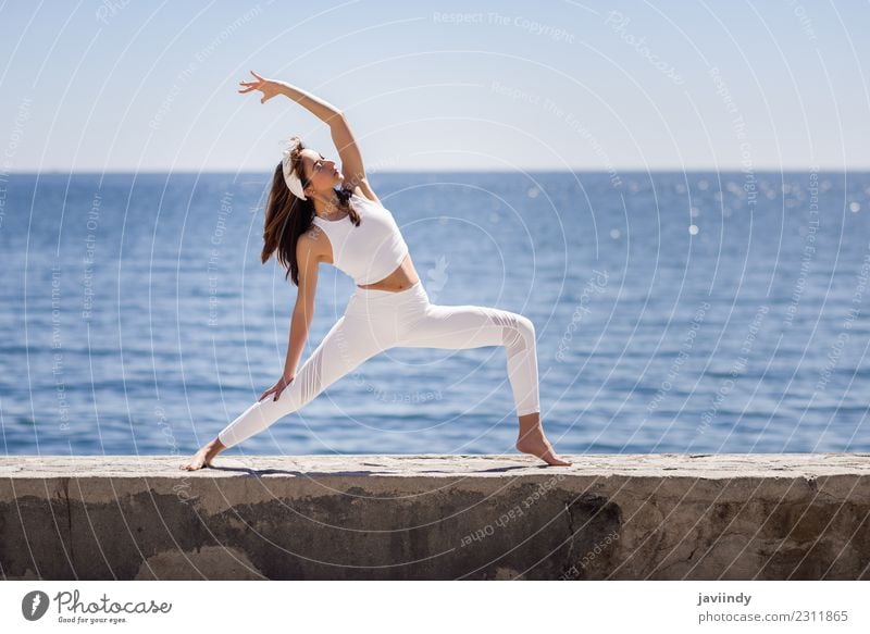 Young woman doing yoga in the beach. Lifestyle Beautiful Wellness Relaxation Meditation Summer Beach Ocean Sports Yoga Human being Youth (Young adults) Woman
