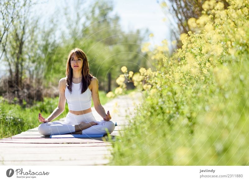 Young woman doing yoga on wooden road in nature. Lifestyle Beautiful Body Relaxation Meditation Summer Sports Yoga Human being Young man Youth (Young adults)