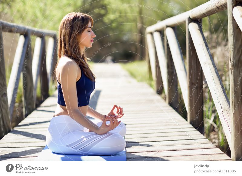 Woman doing yoga in nature. Lotus figure on wooden bridge. Lifestyle Beautiful Body Relaxation Meditation Summer Sports Yoga Human being Young woman