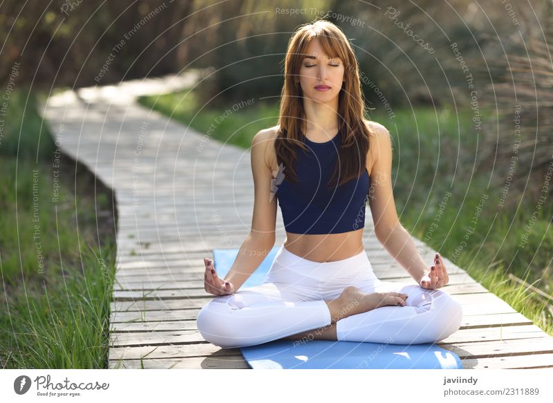 Young woman doing yoga in nature. Lotus figure. Lifestyle Beautiful Body Relaxation Meditation Summer Sports Yoga Human being Youth (Young adults) Woman Adults