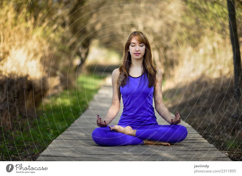 Young woman doing yoga in nature - a Royalty Free Stock Photo from