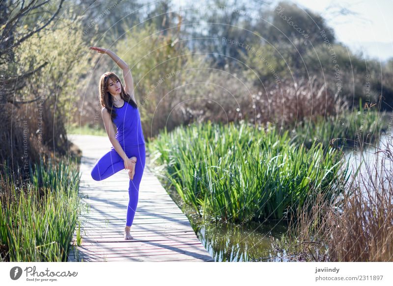 Young woman doing yoga in nature. Lifestyle Happy Beautiful Body Relaxation Meditation Summer Sports Yoga Human being Youth (Young adults) Woman Adults 1