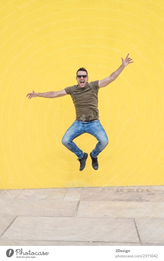 Young man with sunglasses jumping Lifestyle Joy Freedom Human being Youth (Young adults) Man Adults T-shirt Jeans Sunglasses Movement Jump Authentic Uniqueness