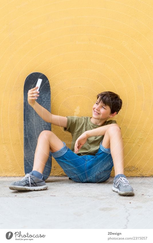 Young teen selfie with skateboard sitting on the floor Lifestyle Joy Relaxation Freedom Summer Sun Child Cellphone PDA Internet Boy (child) Man Adults