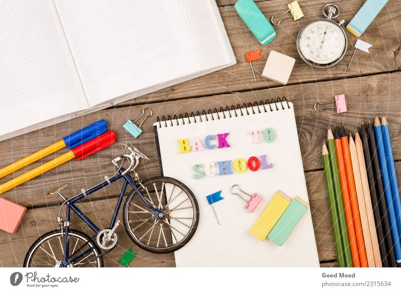 inscription of "back to school", bicycle model, stopwatch, book a