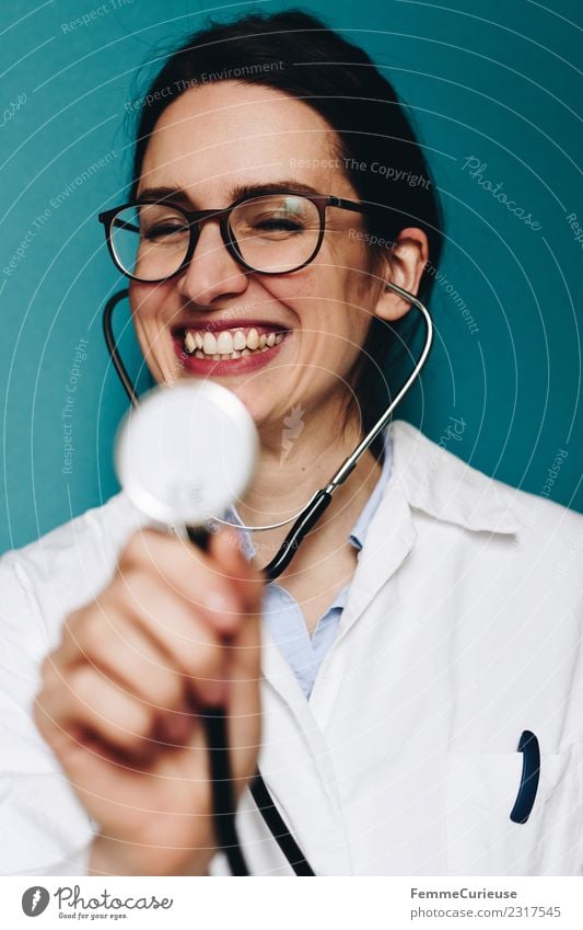 Female doctor fooling around with her stethoscope Work and employment Profession Doctor Feminine Young woman Youth (Young adults) Woman Adults 1 Human being