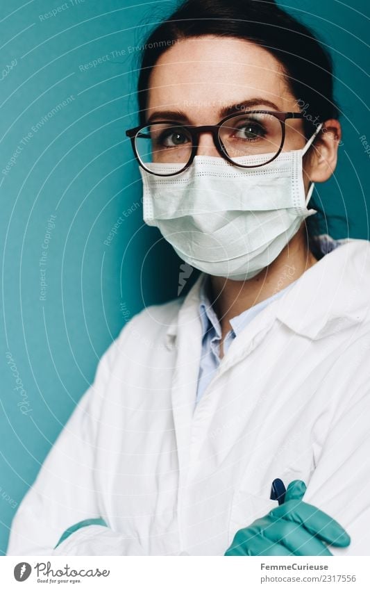 Female doctor wearing a face mask and protective gloves Work and employment Profession Doctor Feminine Young woman Youth (Young adults) Woman Adults 1
