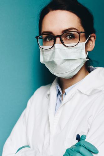 Female doctor wearing a face mask and protective gloves Work and employment Profession Doctor Feminine Young woman Youth (Young adults) Woman Adults 1