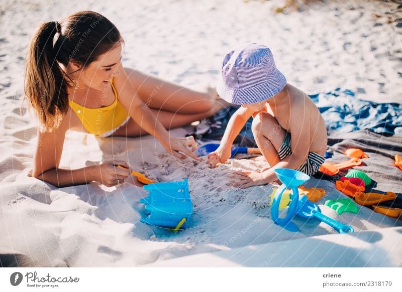 Mother and toddler son playing with toys at beach Lifestyle Joy Happy Leisure and hobbies Playing Vacation & Travel Summer Sun Beach Ocean Child Toddler Woman
