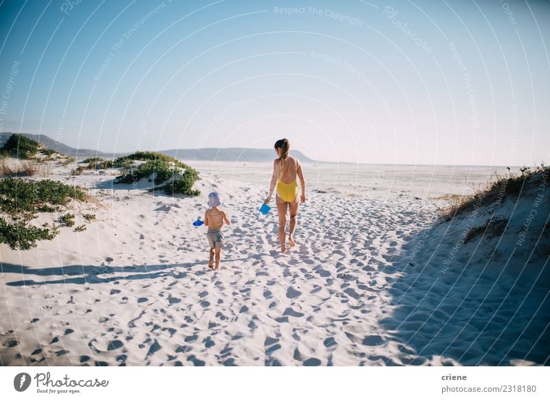 Mother and son walking on the beach together Lifestyle Joy Happy Leisure and hobbies Playing Vacation & Travel Summer Sun Beach Ocean Child Toddler Woman Adults