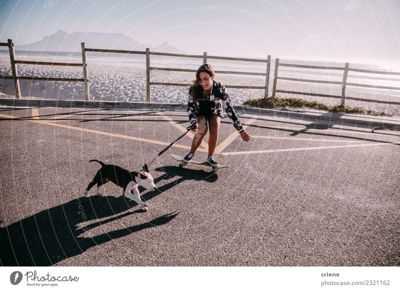 Happy young adult hipster girl on skateboard with puppy Joy Playing Summer Beach Woman Adults Family & Relations Friendship Group Animal Pet Dog Love Embrace