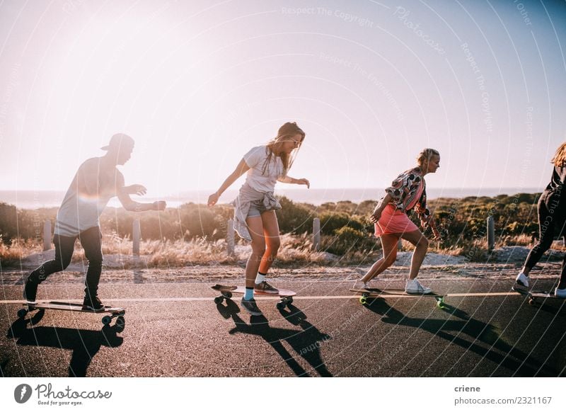 Group of hipster friends longboarding on the road in summer Lifestyle Joy Happy Leisure and hobbies Vacation & Travel Summer Sunbathing Beach Ocean Woman Adults