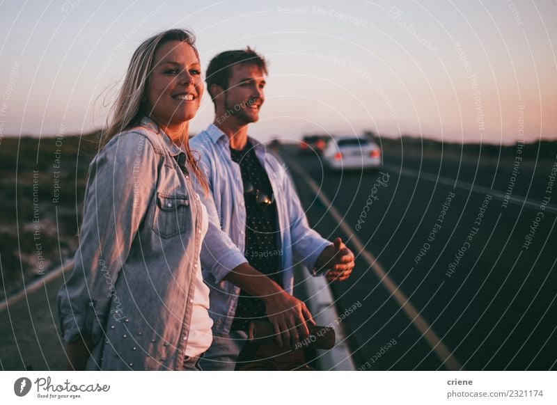 Young adult adventerous couple hitchhiking together Lifestyle Happy Beautiful Leisure and hobbies Vacation & Travel Tourism Trip Adventure Summer Human being