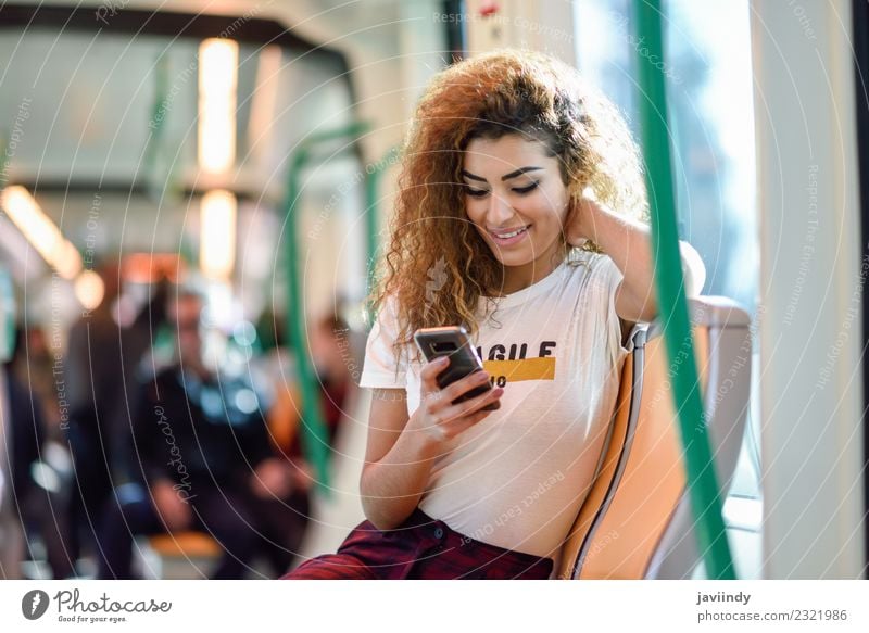 Woman inside subway train looking at her smartphone Lifestyle Beautiful Hair and hairstyles Vacation & Travel Tourism Trip Telephone Human being Feminine