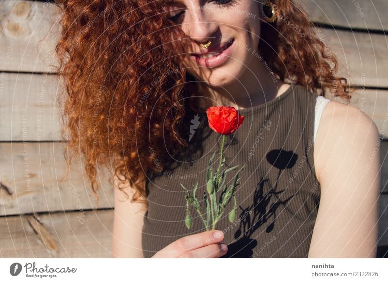 Young redhead woman holding a poppy in her hands Lifestyle Style Joy Beautiful Hair and hairstyles Skin Face Wellness Harmonious Senses Relaxation Human being