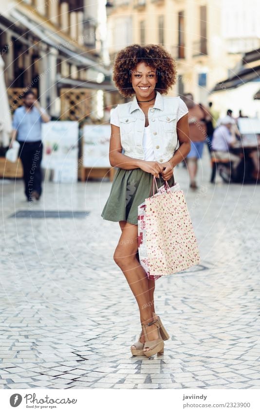 Black woman, afro hairstyle, with shopping bags in the street Lifestyle Shopping Style Hair and hairstyles Human being Feminine Young woman Youth (Young adults)