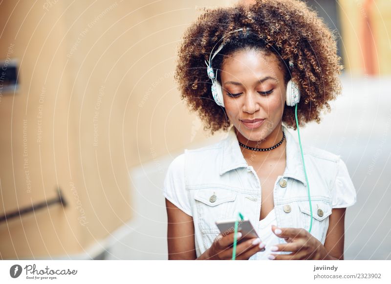 Black woman listening to the music with headphones Lifestyle Style Joy Happy Beautiful Hair and hairstyles Face Music Telephone PDA Human being Young woman