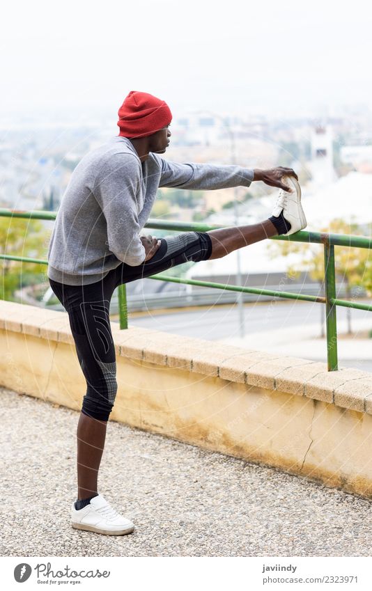 Black man doing stretching after running outdoors. Lifestyle Body Winter Sports Jogging Human being Masculine Young man Youth (Young adults) Man Adults 1
