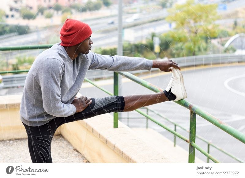 Black man doing stretching after running outdoors Lifestyle Body Winter Sports Jogging Human being Masculine Young man Youth (Young adults) Man Adults 1