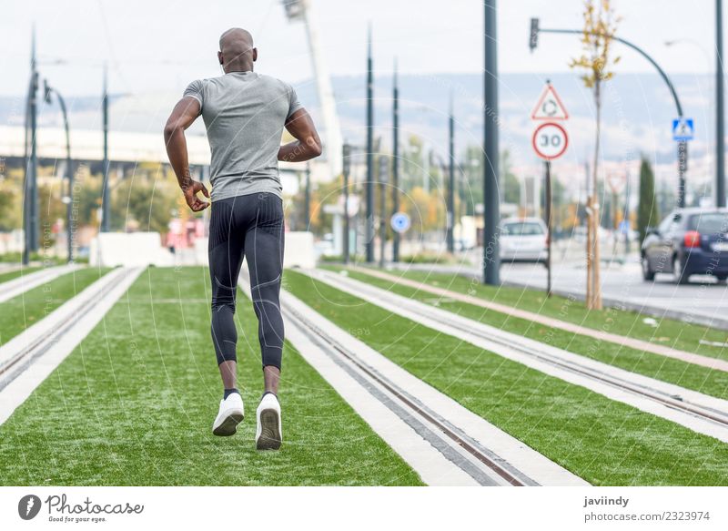 Back view of black man running in urban background. Lifestyle Body Sports Jogging Human being Masculine Young woman Youth (Young adults) Man Adults 1