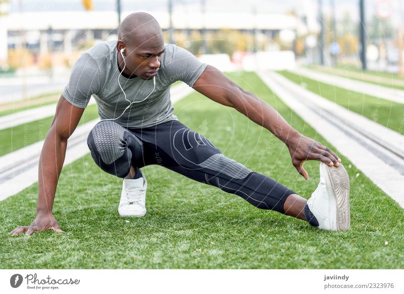 Black man doing stretching after running in urban background Lifestyle Body Sports Jogging Human being Masculine Young man Youth (Young adults) Man Adults 1