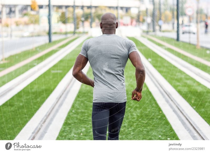 Young African-American black man jogging and running on a path and