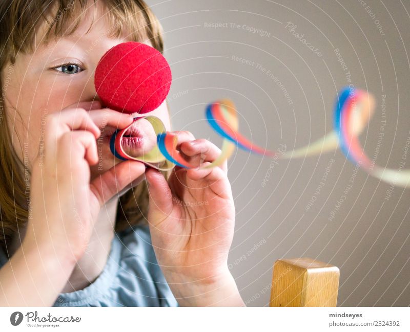 Blond girl with clown nose blows a streamer through the picture. Carnival Feminine Child Infancy Head 1 Human being 3 - 8 years Circus Party