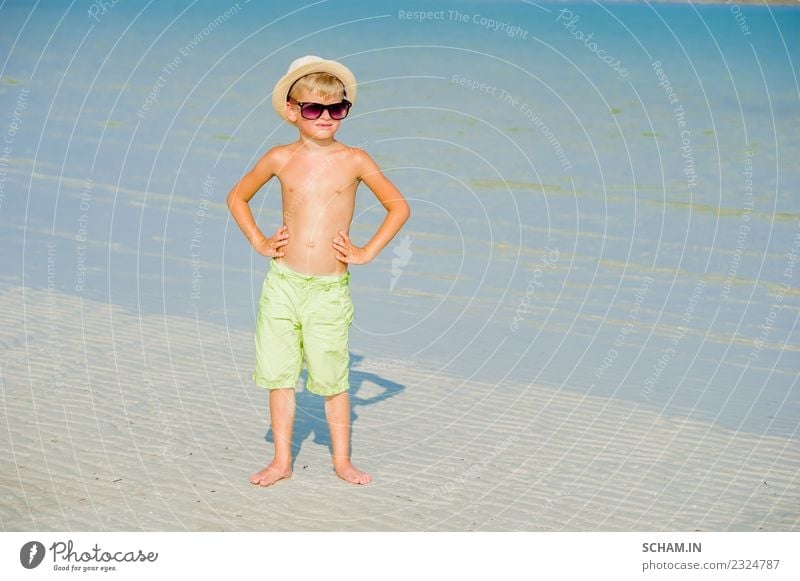 Portrait of a handsome boy on the desert sunny beach Lifestyle Joy Playing Summer Ocean Island Infancy Landscape Sunglasses Smiling Happiness Together 8-9 years