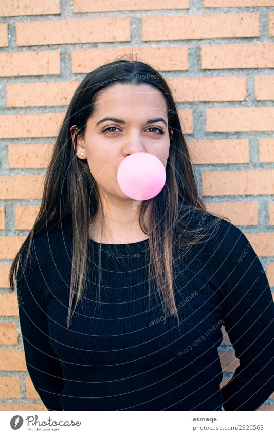 portrait of young woman eating bubble gum in brick background Chewing gum Nutrition Lifestyle Healthy Wellness Vacation & Travel Girl Young woman