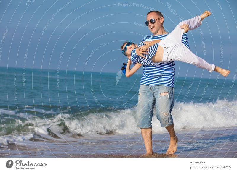 Father and son playing on the beach at the day time. Lifestyle Joy Happy Relaxation Leisure and hobbies Playing Vacation & Travel Trip Freedom Camping Summer