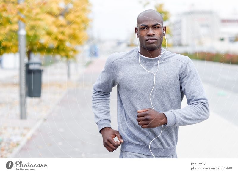 Attractive black man running in urban background. Lifestyle Body Sports Jogging Headset Human being Masculine Man Adults Youth (Young adults) 1 18 - 30 years
