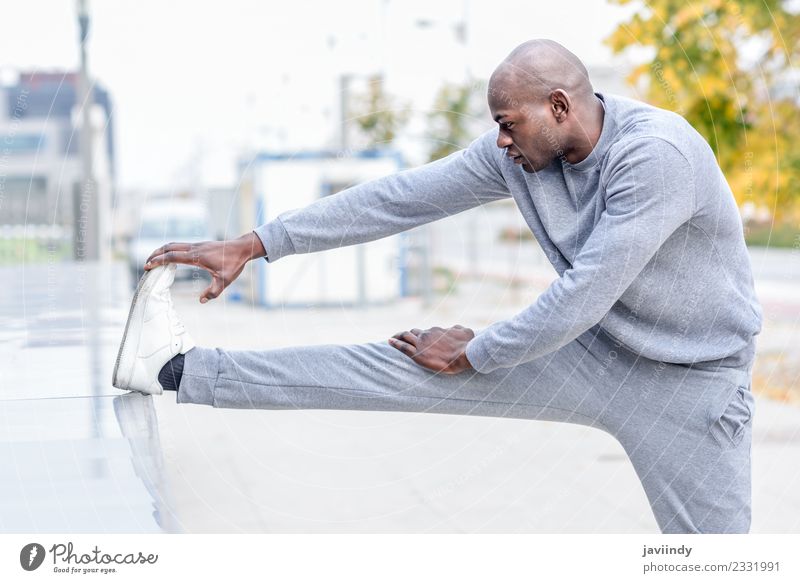 Black man doing stretching after running outdoors Lifestyle Body Sports Jogging Human being Man Adults Youth (Young adults) Legs 1 18 - 30 years Fitness
