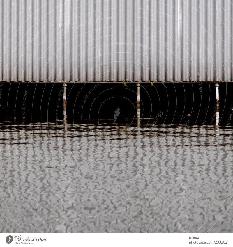 boathouse Water River bank Wall (barrier) Wall (building) Facade Metal Steel Rust Brown Gray Black White Corrugated sheet iron Support Channel Boathouse