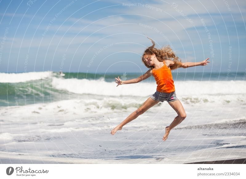 teen girl jumping on the beach at blue sea shore in summer vacation at the day time Lifestyle Joy Happy Beautiful Leisure and hobbies Playing Vacation & Travel