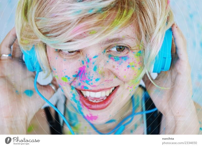 Young woman with paint in her face is listening to music Lifestyle Style Design Joy Beautiful Make-up Wellness Leisure and hobbies Human being Feminine