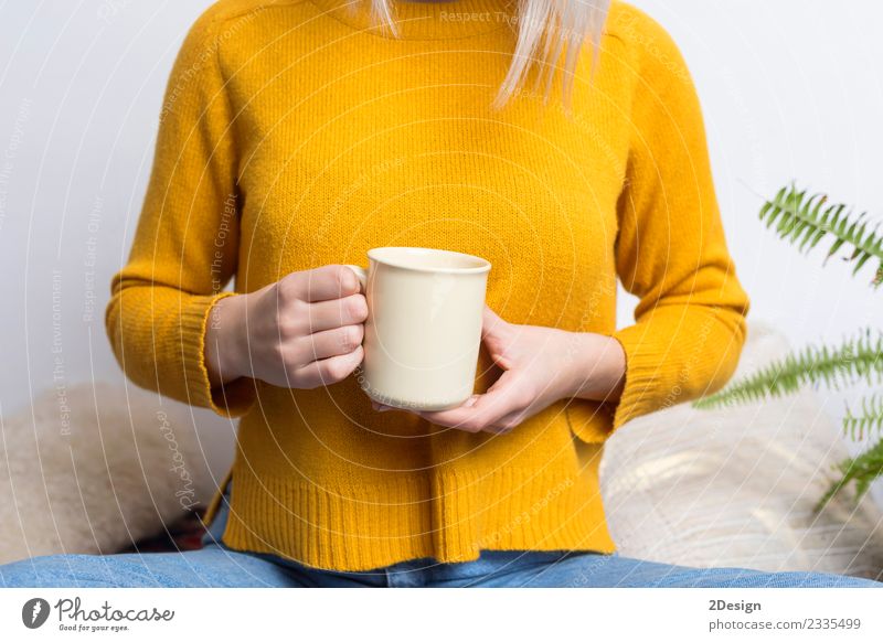 Happy young woman holding a cup of tea or coffee Breakfast Beverage Hot drink Coffee Espresso Tea Pot Cup Lifestyle Style Beautiful Face Relaxation Business