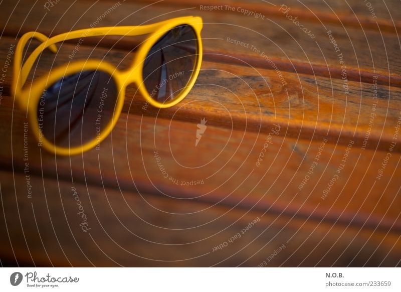 summer sunglasses Lifestyle Table Wooden table Sunglasses Brown Yellow Serene Summer Summer vacation Summery Colour photo Exterior shot Deserted
