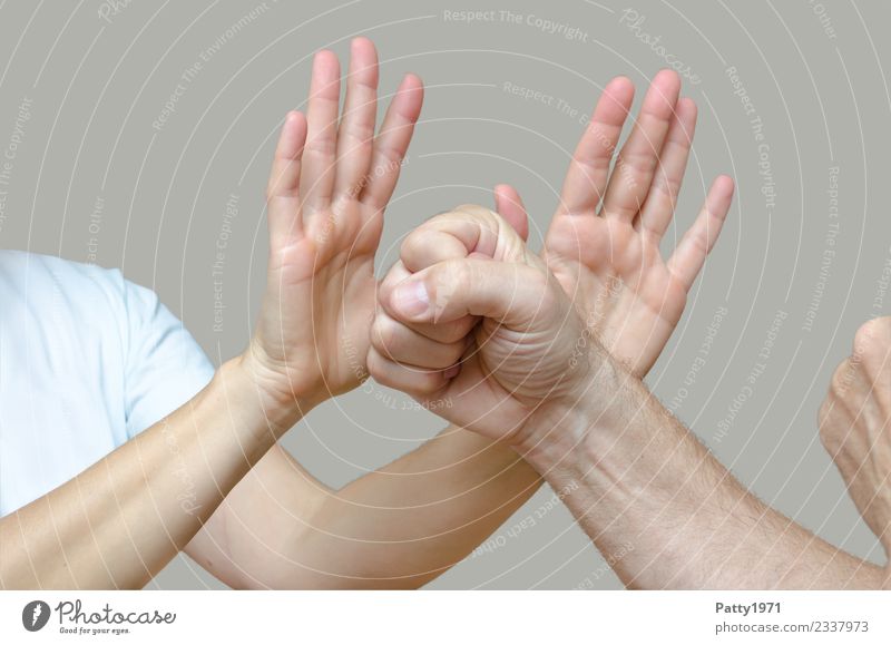 Woman has raised both hands defensively against a man who threatens her with clenched fists. Detail of the hands. Human being Masculine Feminine Adults Man Arm