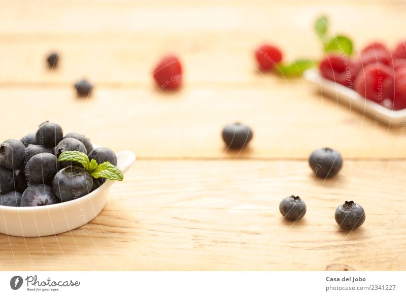 fresh and raw blueberries and raspberries on wooden background Food Fruit Dessert Nutrition Eating Breakfast Vegetarian diet Diet Plate Bowl Lifestyle Design