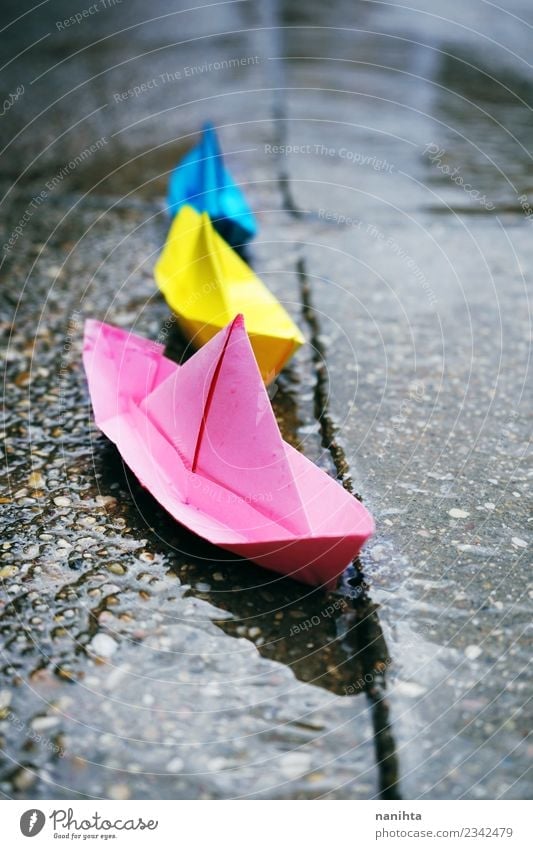 Color paper boats in a rainy day Leisure and hobbies Water Climate Weather Bad weather Rain Transport Street Navigation Paper Paper boat Origami