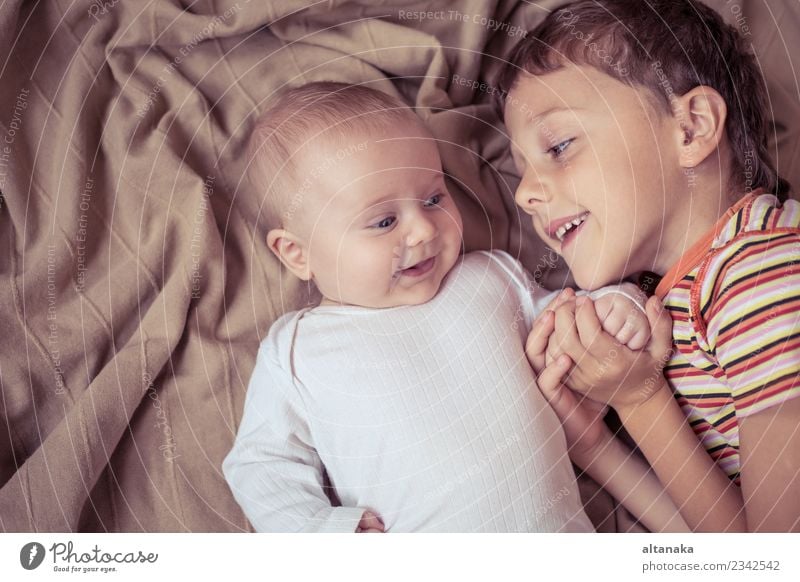 little boy playing with newborn on the bed at the day time Joy Happy Playing Bedroom Child Baby Toddler Boy (child) Family & Relations Friendship Infancy Hand