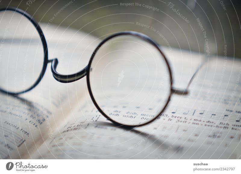 see Eyeglasses sehkrücke Reading Shallow depth of field Blur Book Sing Song book Musical notes Religion and faith Belief Church nickel glasses Glass Vision